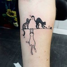 a cat and dog tattoo on the left leg, which is drawn in black ink