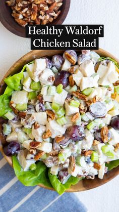 a salad with grapes, celery and walnuts in a wooden bowl on a striped tablecloth