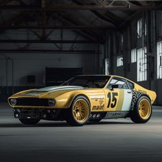 a yellow sports car parked in an empty garage with no one around it's wheels