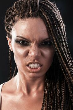 a close up of a woman with dreadlocks