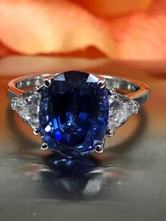 Excited to share this item from my #etsy shop: Oval Ceylon Blue Sapphire And Trillion Accents Set In A Basket Style Setting  In 14K White Gold  #5629 Blue Sapphire Gemstone With Center Stone, Fine Jewelry Trillion Cut Sapphire Ring With Accent Stones, Sapphire Trillion Cut Ring, Trillion Cut Sapphire Gemstone Ring, Blue Sapphire Ring With Pear-shaped Center Stone, Sapphire Gemstone Ring, Trillion Cut, Trillion Cut Sapphire Ring With Center Stone, Formal Trillion-cut Sapphire Ring With Accent Stones, Gia Certified Sapphire Ring