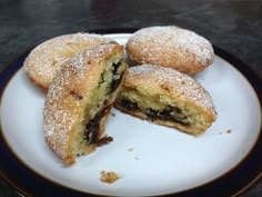 some powdered sugar filled pastries on a plate