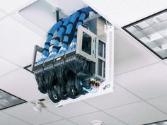 wires and cables are connected to the inside of a server compartment in an office building