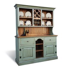 a green china cabinet with glass doors and drawers