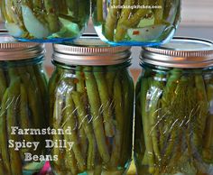 four jars filled with pickled green beans