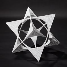 a white sculpture on a black background that looks like an origami star with intersecting lines