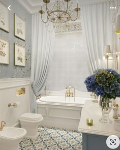 a bathroom with a chandelier, toilet and bathtub