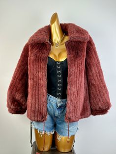 This vintage 70s faux fur coat is Burgundy in color. The soft faux fur coat for women is fully lined, and looks to be a custom made piece. It is fashioned of faux fur and has a front metal zip closure with 2 front pockets. This vintage faux fur coat is waist length and is in excellent condition. There is no marked size. It fits like a small/Medium. The marked brand is "Hillmoor New York". MEASUREMENTS: (Measurements are taken of the garment laying flat and not stretched) BUST: 38 WAIST: 40 LENGTH: 24" (From shoulder to hem) SHOULDERS: 19" SLEEVE LENGTH: 23" SHIPPING: Once your order is processed you can expect your package to ship the next business day and arrive in 2 to 5 business days. FOR SALES AND PROMOTIONS, FOLLOW US HERE! Instagram: @shabbybabevintage facebook.com/shabbybabe Red Fur Coat With Faux Fur Trim, Red Fur Coat With Faux Fur Trim For Fall, Red Faux Fur Coat For Fall, Red Faux Fur Outerwear For Fall, Red Fur Coat For Fall, Red Faux Fur Coat, Vintage Faux Fur Coat, Coat For Women, Tent Dress