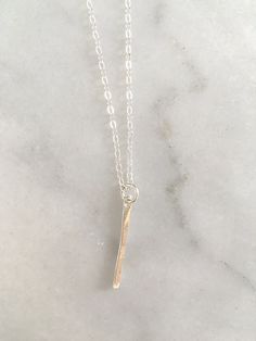 the vertical bar is hammered and hangs 1'' in length on an 18'' chain.  made from 14k gold filled or sterling silver wire. hand formed and hammered for a one-of-a-kind finished product. Vertical Bar Necklace, Vertical Bar, Gold Bar Necklace, Hammered Sterling Silver, Necklace Layering, Silver Line, Bar Pendant, Layering Necklace, Gold Bar