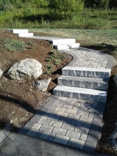 a stone walkway with steps leading up to it