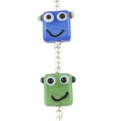 two blue and green glass beads with eyes on them, one has a smiling face