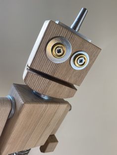 a robot made out of wood with two eyes