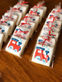 some cookies are wrapped in plastic and tied with red, white and blue ribbons on a wooden table