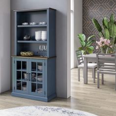 a dining room table with chairs and a blue china cabinet