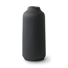 a black vase sitting on top of a white surface