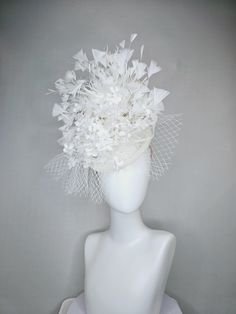 From the 2024 Featured Milliner of the Kentucky Derby Museum  Gorgeous Kentucky Derby hat fascinator  kentucky derby hat fascinator ivory white sinamay with bow and netting,ivory white silk flowers with pearls, and branching white feathers headband attachment.  each hat is totally one of a kind! no two are alike! Check out my The Hat Doctor amazing news story feature!! https://www.wdrb.com/derby_148/kentucky-derby-hat-showcase-features-real-life-radiologist-turned-hat-doctor/article_bbfd9b7c-a0b Tulle Hat For Weddings And Kentucky Derby, White Mini Hat For Kentucky Derby Ceremony, White Mini Hats For Kentucky Derby Ceremonies, Fitted White Ceremony Headpiece, White Fitted Ceremony Headpieces, Fitted White Headpiece For Ceremony, Feathered Wedding Fascinator For Royal Ascot, Feathered Fascinator For Wedding At Royal Ascot, Feather Fascinator For Wedding And Royal Ascot