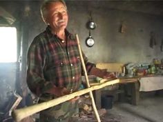 a man holding a wooden stick in his hands