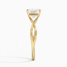 a yellow gold ring with a diamond in the center