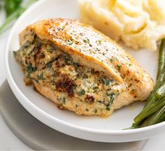 a white plate topped with meat and green beans