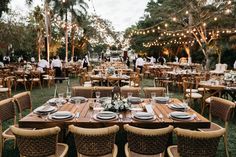 an outdoor dining area with tables and chairs set up for a formal dinner in the evening