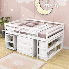 a child's bed with drawers underneath it and a moon on the wall above