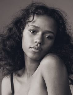 a black and white photo of a woman with curly hair