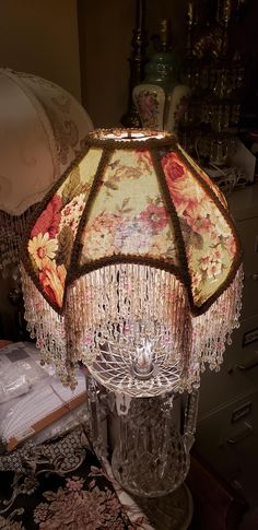 a lamp that is sitting on top of a table next to a dresser and drawers