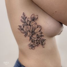 a close up of a woman's stomach with flowers on it