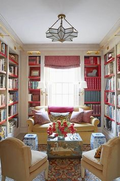 a living room filled with furniture and lots of books