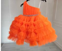 Make her special day unforgettable with our Orange One Shoulder Girl Dress! Whether she's celebrating a birthday, acting as a flower girl, or participating in a wedding as a junior bridesmaid, this dress is sure to make her feel like a princess. The one-shoulder design adds a touch of elegance, while the vibrant orange color makes a bold statement. The dress is crafted from high-quality materials, ensuring comfort and style all day long. Perfect for proms, weddings, or any special occasion, this dress is a must-have for your little one's wardrobe. Order now and let her shine! Dress Baby Girl, Baby Ball, Orange Baby, Baby Gown, Dress Flower, Bridesmaid Wedding, Birthday Dress