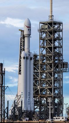 a large white rocket sitting on top of a metal structure