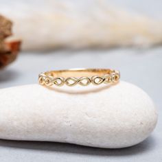 a gold ring sitting on top of a rock