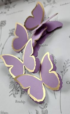 purple butterflies with gold edges on a white background