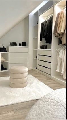 a bedroom with white furniture and lots of closet space, including a large rug on the floor