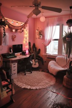 a living room with pink walls and lots of decorations on the ceiling, including a guitar