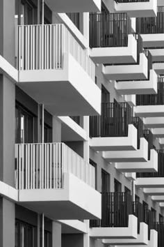 an apartment building with balconies and balconies in black and white photo