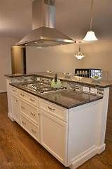 a large kitchen with an island in the middle of it and a stove top oven