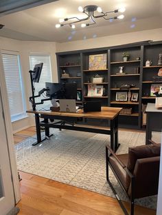 a home office with desk, chair and bookshelf