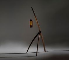 a light that is on top of a wooden pole with a lamp in the middle