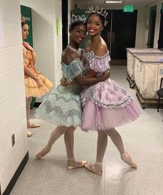 two young ballerinas are posing for the camera