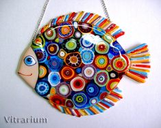 a colorful glass fish hanging on a chain