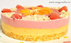 a close up of a cake on a plate with strawberries and oranges in it