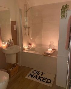 a bathroom that has candles on the floor