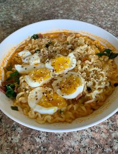 a white bowl filled with noodles and eggs