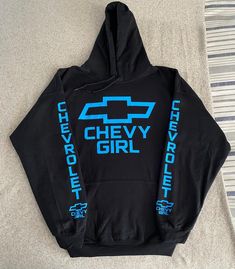 Chevy Sky Blue Logo Women Hoodie, just in time for the winter. Brand is Gildan, Handmade 8.0 oz., 50/50 cotton/polyester Reduced pilling and softer air-jet spun yarn Double-lined hood with color-matched drawcord 1x1 athletic rib knit cuffs and waistband with spandex Front pouch pocket Double needle stitching at waistband and cuffs Quarter-turned Tearaway label    And every Hoodie is made to order. Many different colors upon request Make sure to message me with the color you want. Shooting Range Outfit Woman, Western Hoodies, Sky Blu, Country Fits, Sweatshirt Ideas, Country Clothes, Chevy Girl