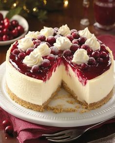 a cheesecake with berries and whipped cream on top