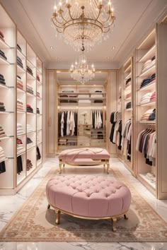 a walk - in closet with chandelier, pink bench and clothes on shelves