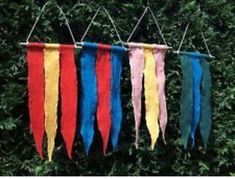 four colorful ribbons hanging from a line in front of trees