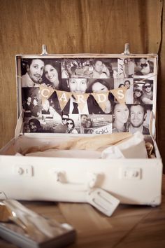 an open suitcase sitting on top of a wooden table