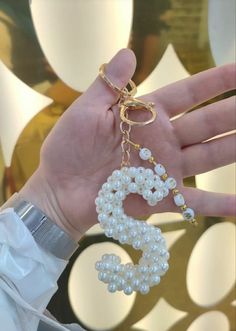 a person is holding some pearls in their hand